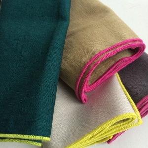 A selection of napkins, all 1 colour with a contrasting colour edge